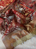 Carmine Red Tissue Silk Saree With Golden Ghungroo Butti Work & Luxury Lace Border