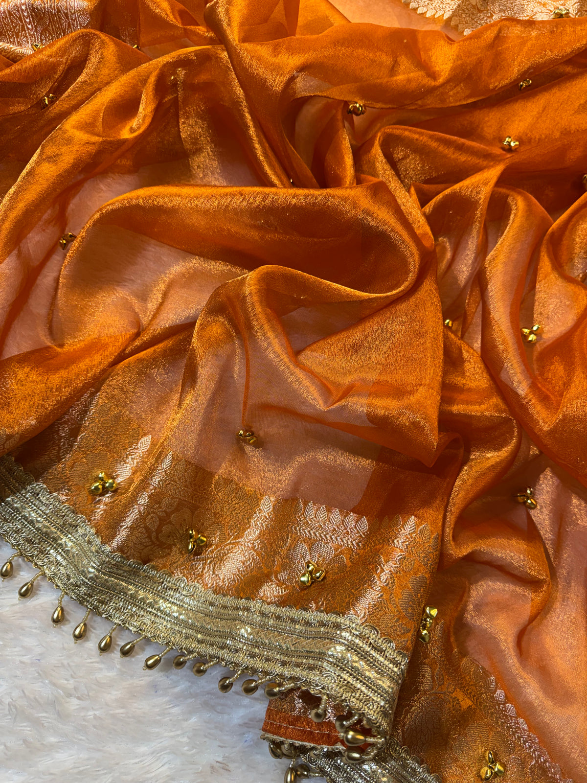 Orange Tissue Silk Saree With Golden Ghungroo Butti Work & Luxury Lace Border